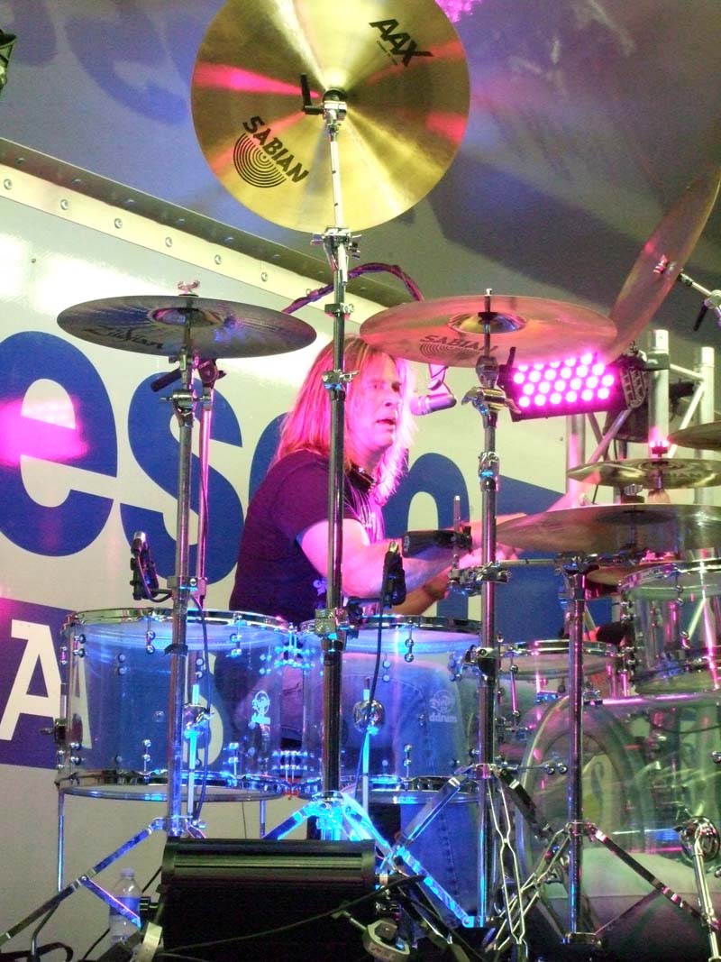 photo of man playing drums